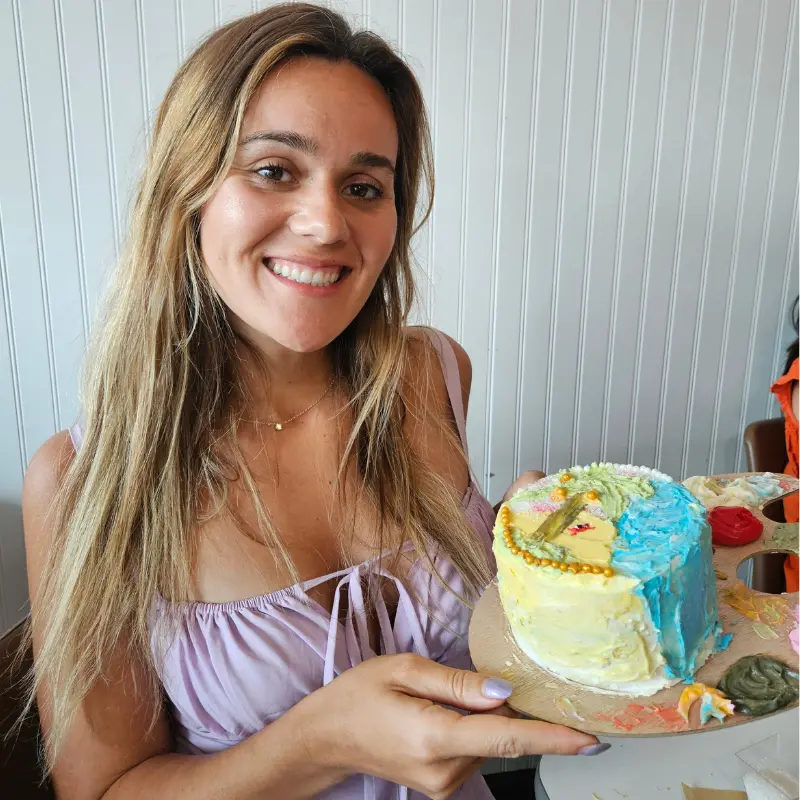 Kaleigh holding a hand-decorated cake